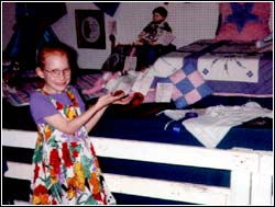 Jordan standing next to her red-ribbon-earning 9 patch pillow...